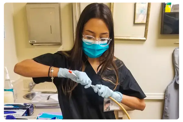 Dental Assistant Course Student with Hand Piece